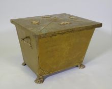An Arts & Crafts brass sarcophagus shaped coal box raised on paw feet, 49 x 39cm