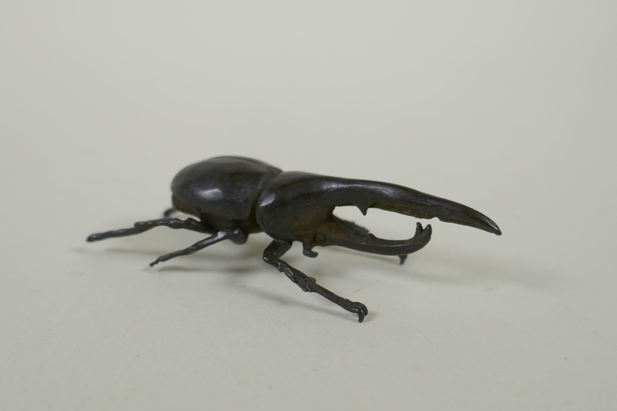 A Japanese style bronze okimono hercules beetle, 7cm