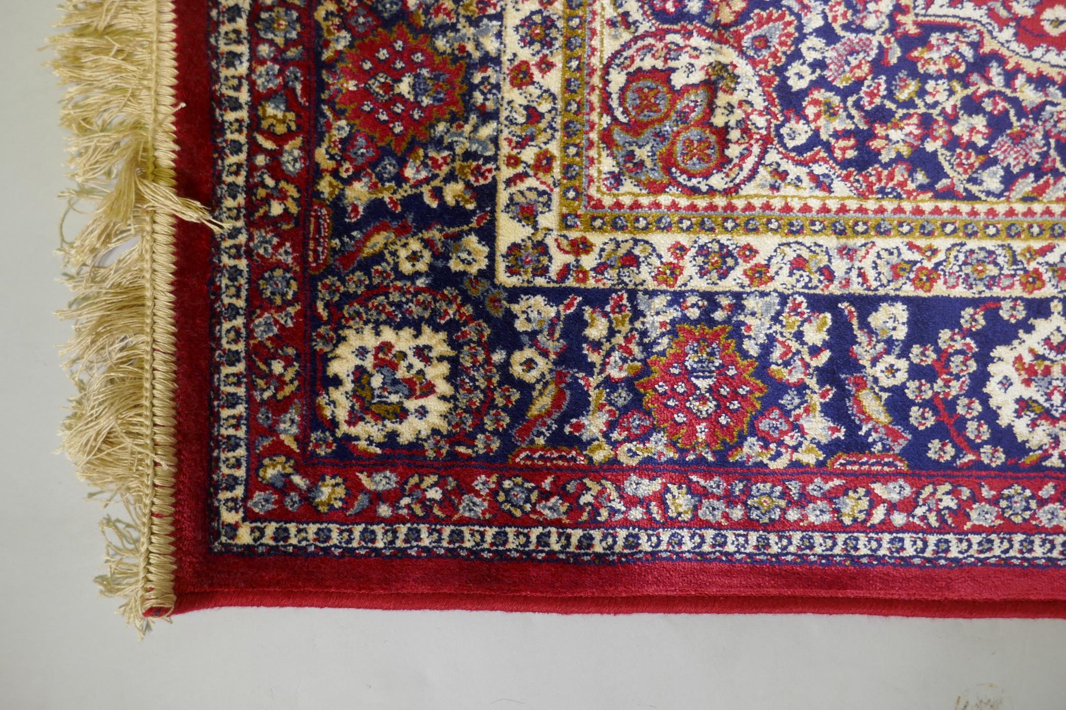 A red ground Kashmir rug with traditional floral medallion design and blue borders, 170 x 120cm - Image 4 of 5