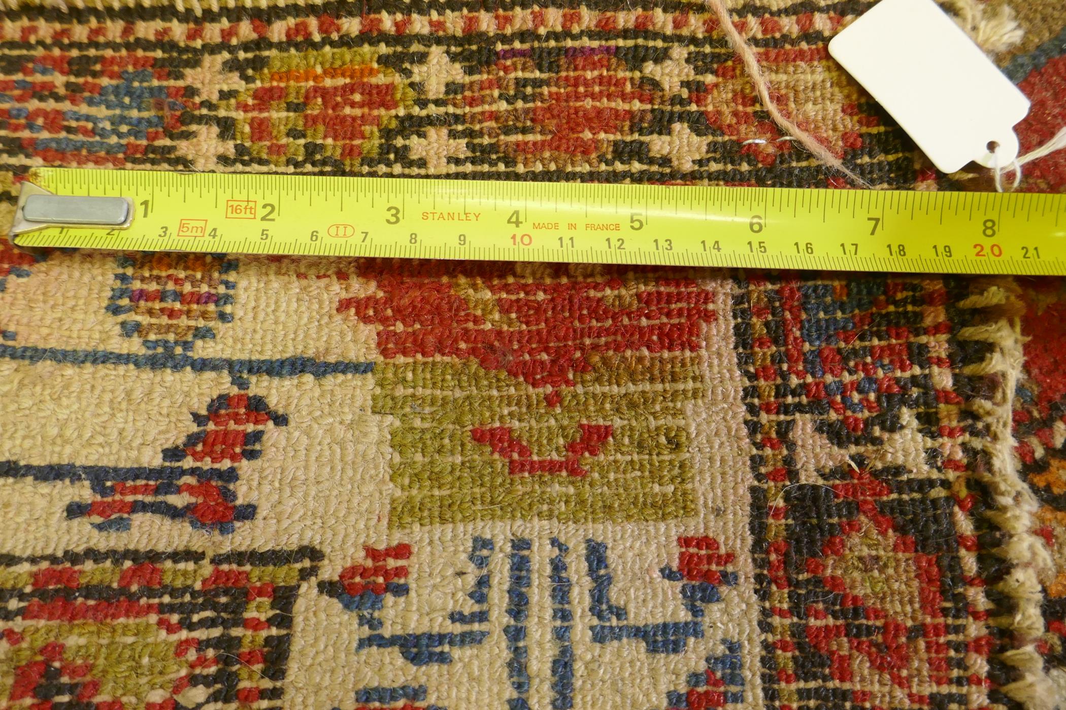 An antique Persian hand woven wool carpet, with medallion design on a red and blue field with - Image 5 of 5