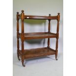 A Victorian mahogany three tier buffet, raised on reeded supports in the manner of Gillows, 89 x
