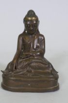 Oriental bronze Buddha with inset glass eyes, possibly Burmese, 17cm high
