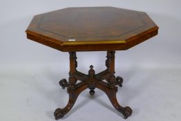 A Victorian inlaid walnut octagonal tilt top occasional table, raised on four turned columns and