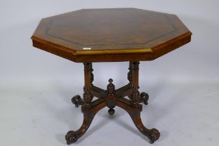 A Victorian inlaid walnut octagonal tilt top occasional table, raised on four turned columns and