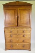 An early C19th oak linen press/housekeeper's cupboard, the upper section with two doors, fitted with
