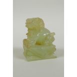 A Chinese carved green jade temple lion, 7cm high