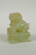 A Chinese carved green jade temple lion, 7cm high