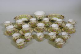 An antique Staffordshire part tea service decorated with foxgloves of various colours, largest