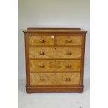 A Victorian walnut chest of two and three drawers with rounded ends, raised on bun supports, 102 x