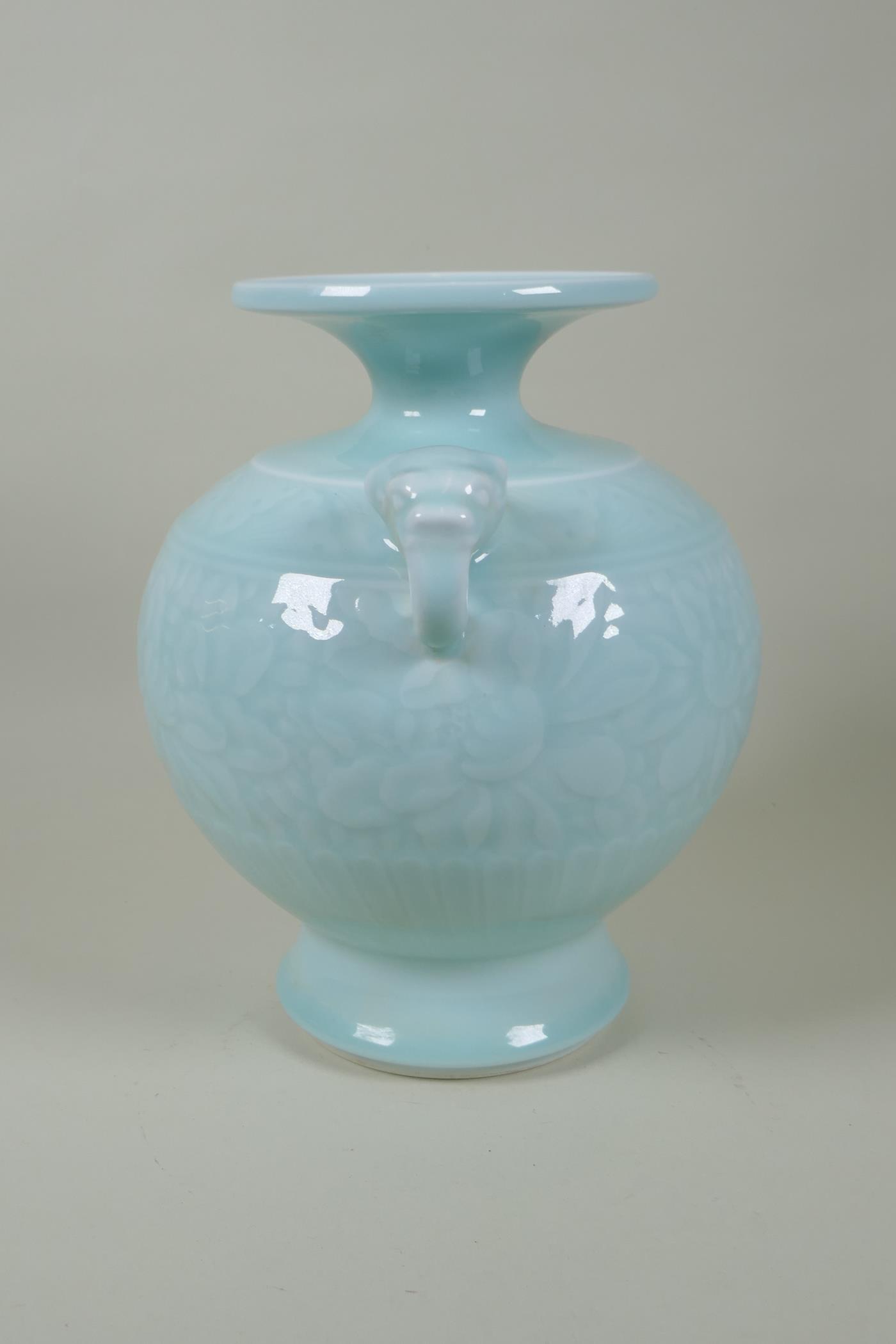 A Chinese celadon glazed porcelain vase with two elephant mask handles and underglaze floral - Image 3 of 6