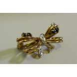 A 9ct gold bow shaped brooch inset with diamonds, 2.5cm wide, 3.6g