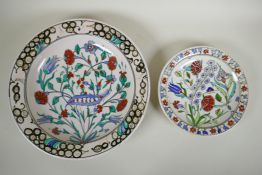 An Iznik style Greek pottery charger by Icaro Rodi with hand painted floral decoration, and