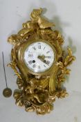 A C19th ormolu cartel wall clock, decorated with a putto and doves, an enamel dial with Roman and