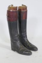 A pair of vintage black and red riding boots with beechwood trees, labelled Maxwell, Dover St.,