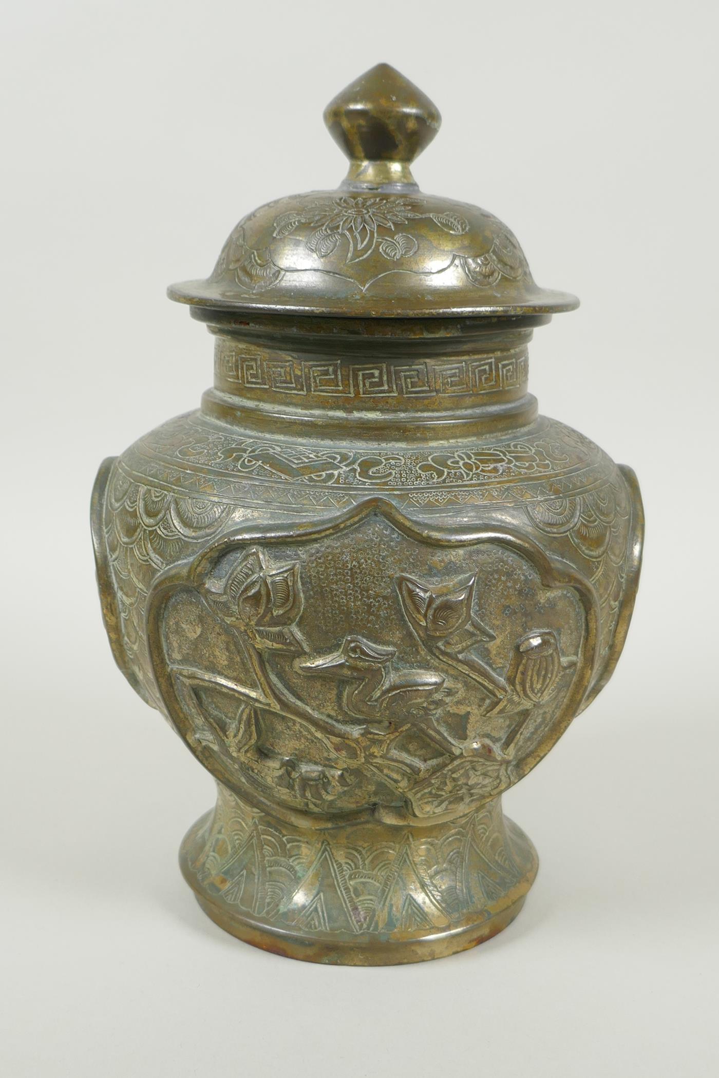 A Chinese gilt bronze meiping jar and cover, with raised decorative panels depicting asiatic animals