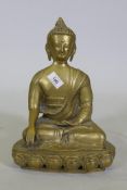 A brass figure of Buddha seated upon a lotus dias, 34cm high