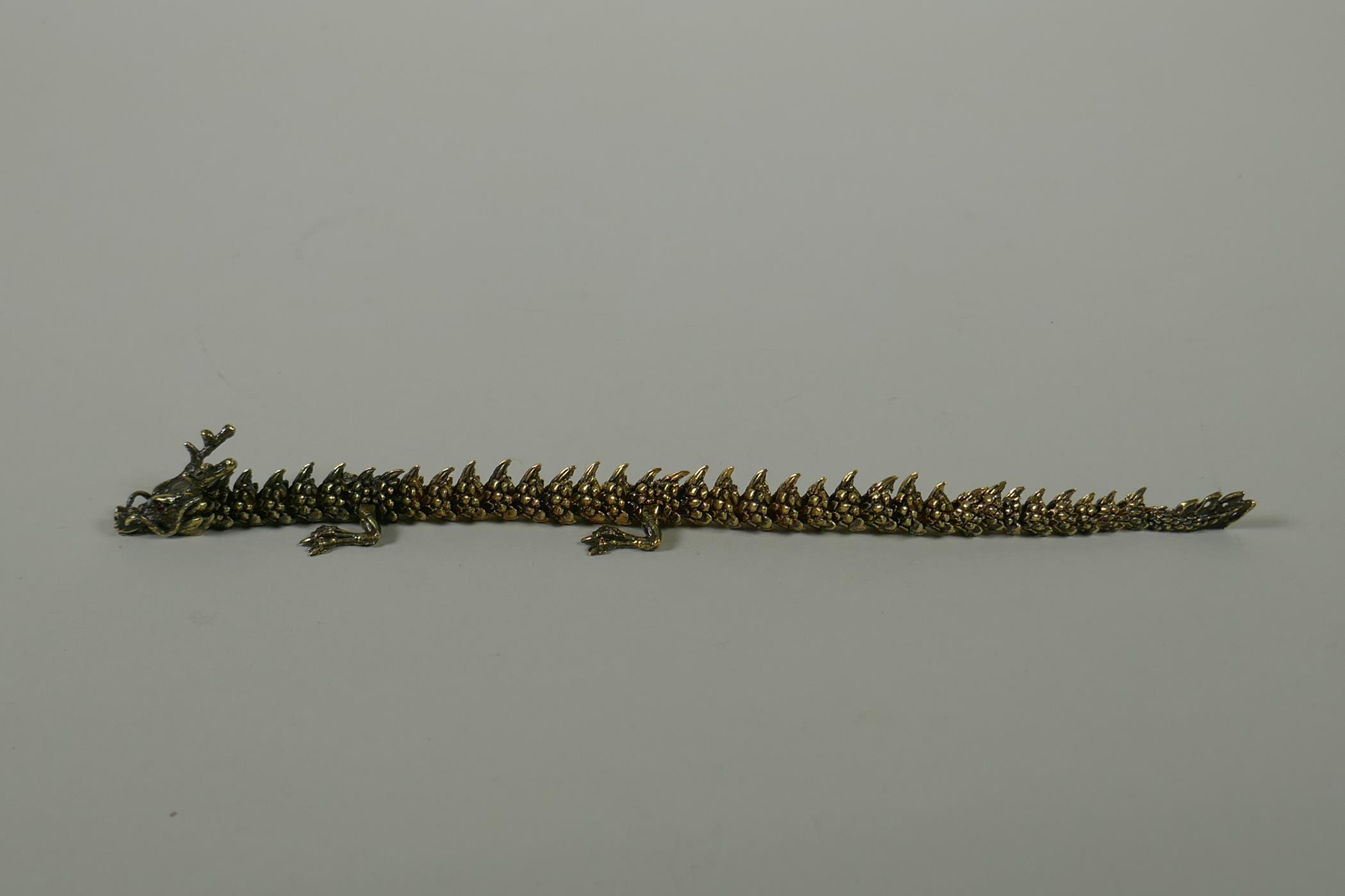 A Japanese Jizai style bronze okimono dragon, with articulated body and legs, 23cm long - Image 3 of 5