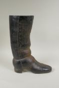 A painted cast iron door stop in the form of a riding boot, 36cm high