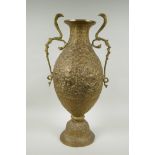 An Indian bronze urn with two handles in the form of cobras, with allover repousse decoration