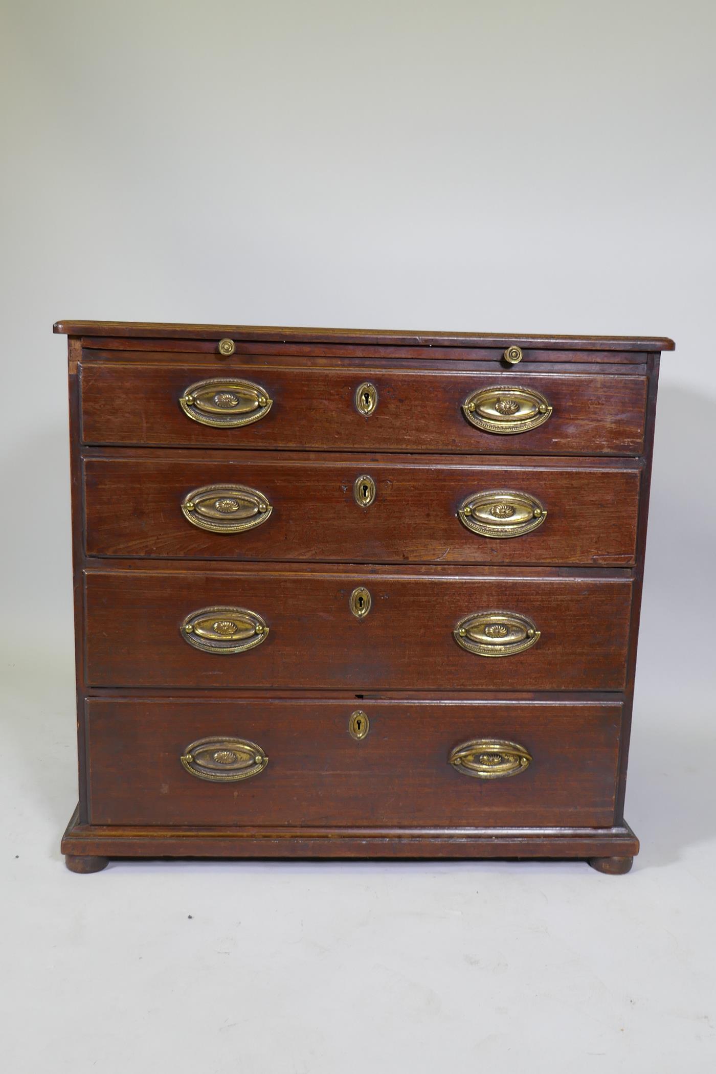 A Georgian mahogany chest of four long drawers under a brushing slide, raised on later bun feet - Image 2 of 5