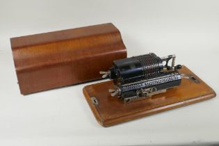 An antique mahogany cased Trinks-Brunsviga mechanical calculator, 38 x 18cm x 16cm