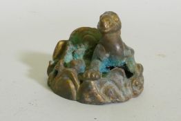 An Eastern bronze figure of a horned dragon, 5cm high