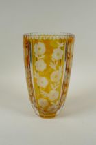 A Bohemian amber cut glass vase with floral decoration, 23cm high