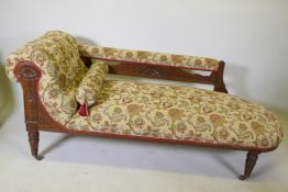 A Victorian walnut chaise longue with carved Grecian style decoration and good upholstery, 180cm