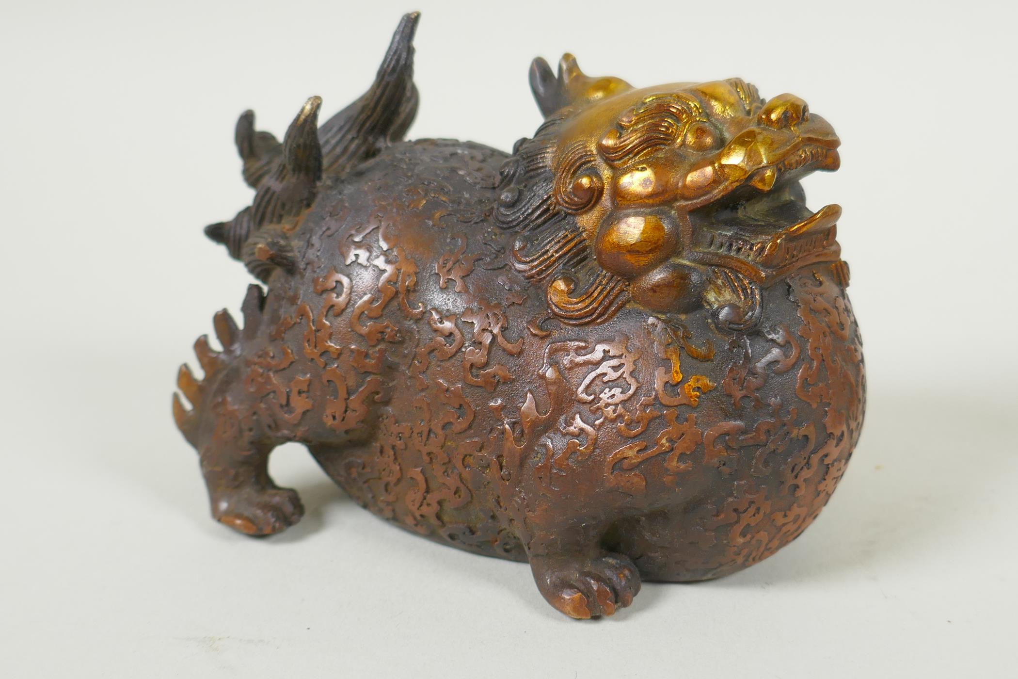 A pair of Chinese filled bronze kylin with gilt heads, 11cm long - Image 2 of 5