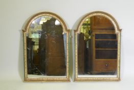 A pair of dome top wall mirrors with painted decoration and faux marble columns, 81 x 55cm