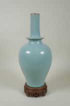 A Chinese Ru ware style porcelain vase, on a carved wood stand, 33cm high