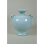 A Chinese celadon glazed porcelain vase with two elephant mask handles and underglaze floral