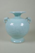A Chinese celadon glazed porcelain vase with two elephant mask handles and underglaze floral