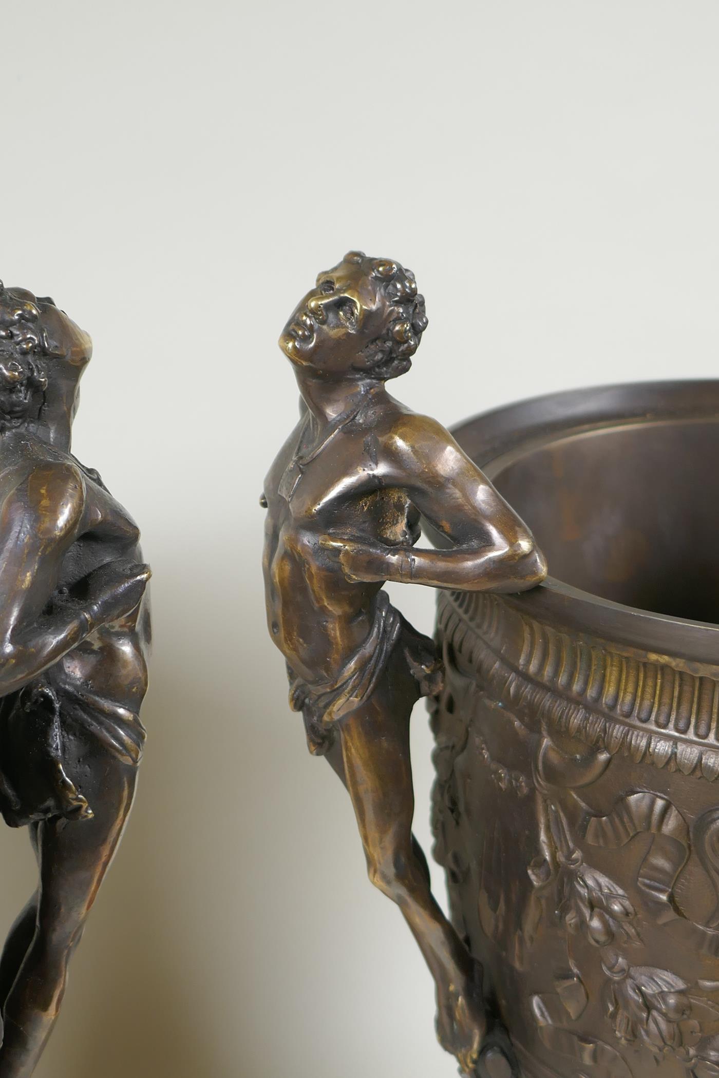 A pair of Grand Tour style bronze urns on red marbled bases, with male figural twin handles, 41cm - Image 3 of 6