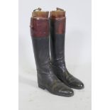 A pair of vintage black and red riding boots with beechwood trees, labelled Maxwell, Dover St.,