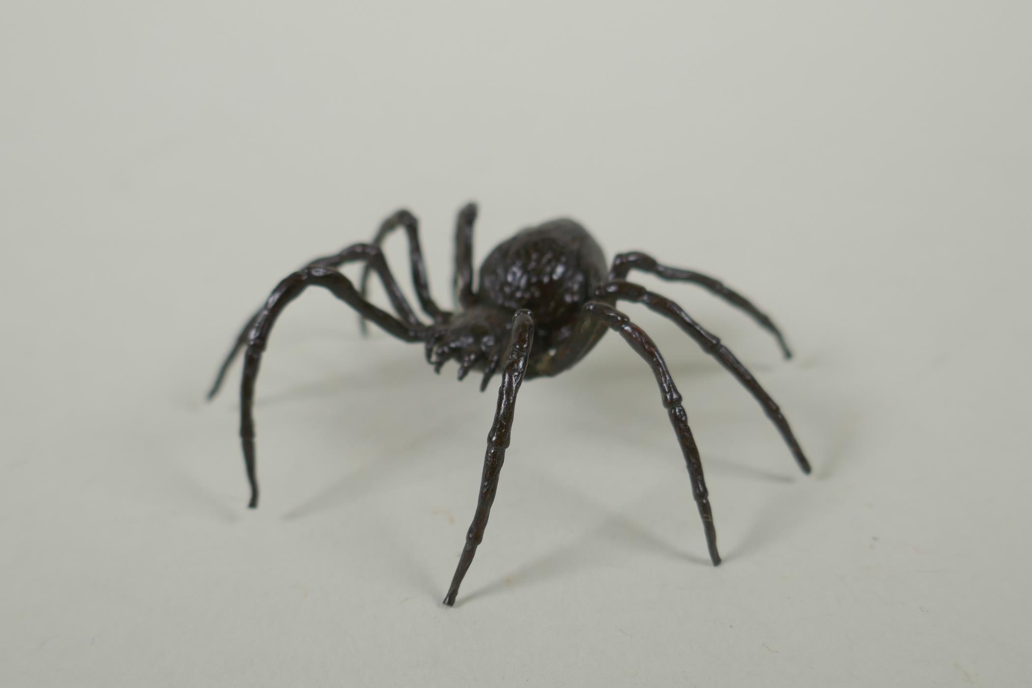 A Japanese style bronze okimono spider, 7cm wide
