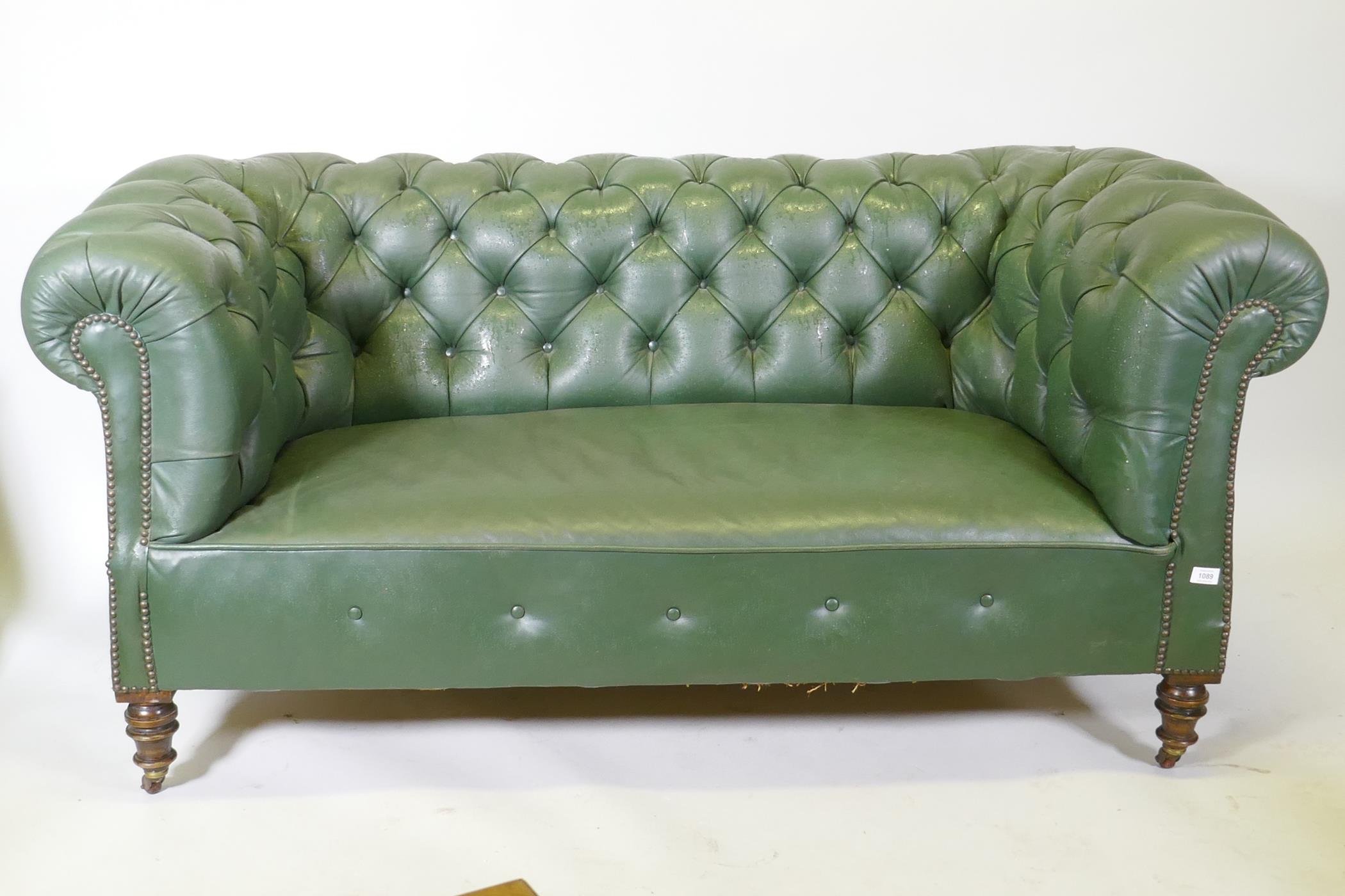 A Victorian button back leather Chesterfield settee, raised on turned supports, 165cm wide