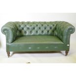 A Victorian button back leather Chesterfield settee, raised on turned supports, 165cm wide