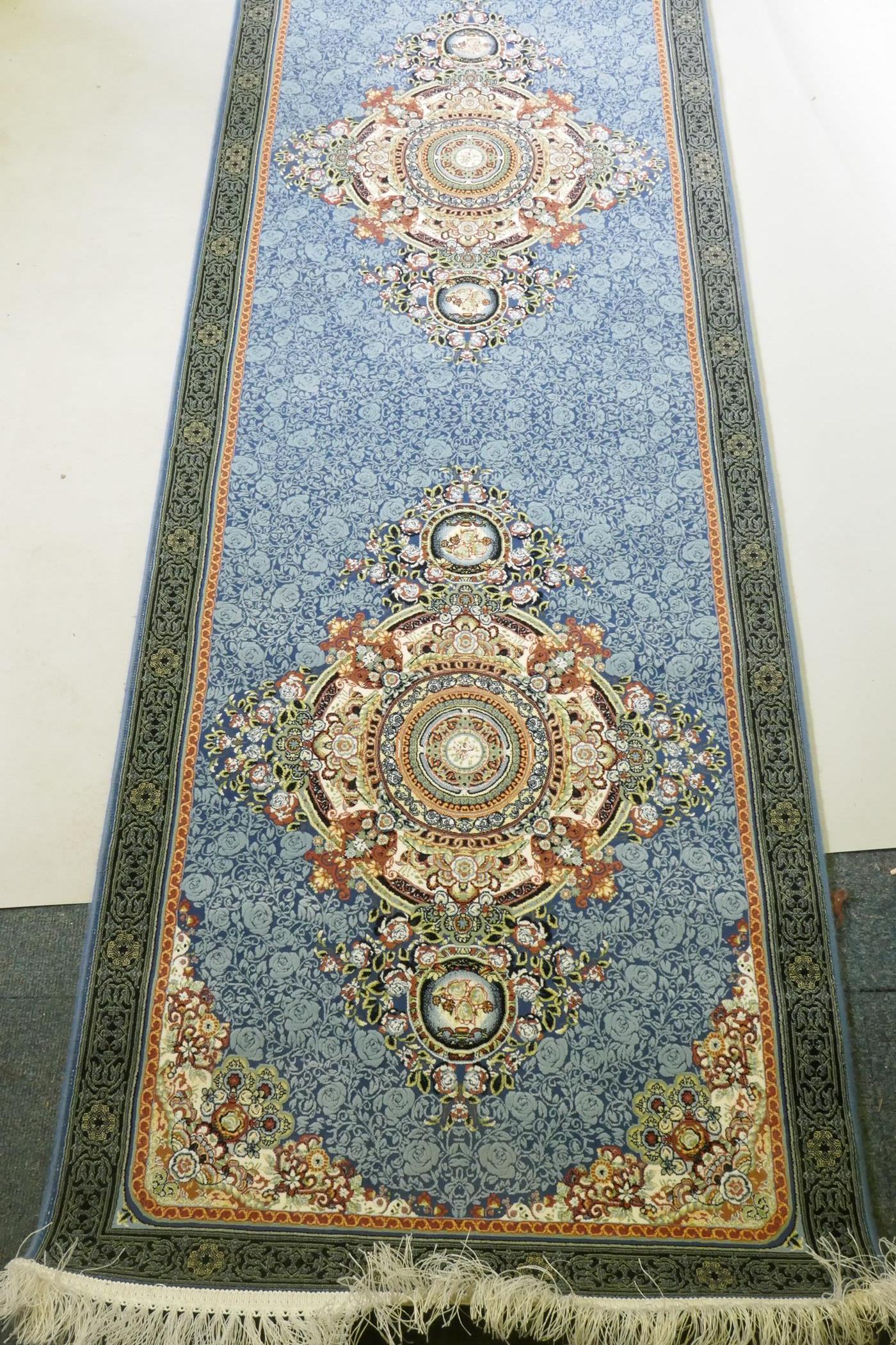 An Iranian fine woven blue ground runner with a medallion design and darker blue border, 80 x 310cm - Image 2 of 5