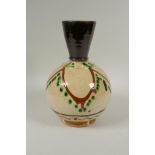 An antique Islamic earthenware vase with cream glazed body and treacle glazed neck, 25cm high