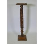 An antique Anglo Indian hardwood torchere with carved spiral leaf decoration to the column, 110cm