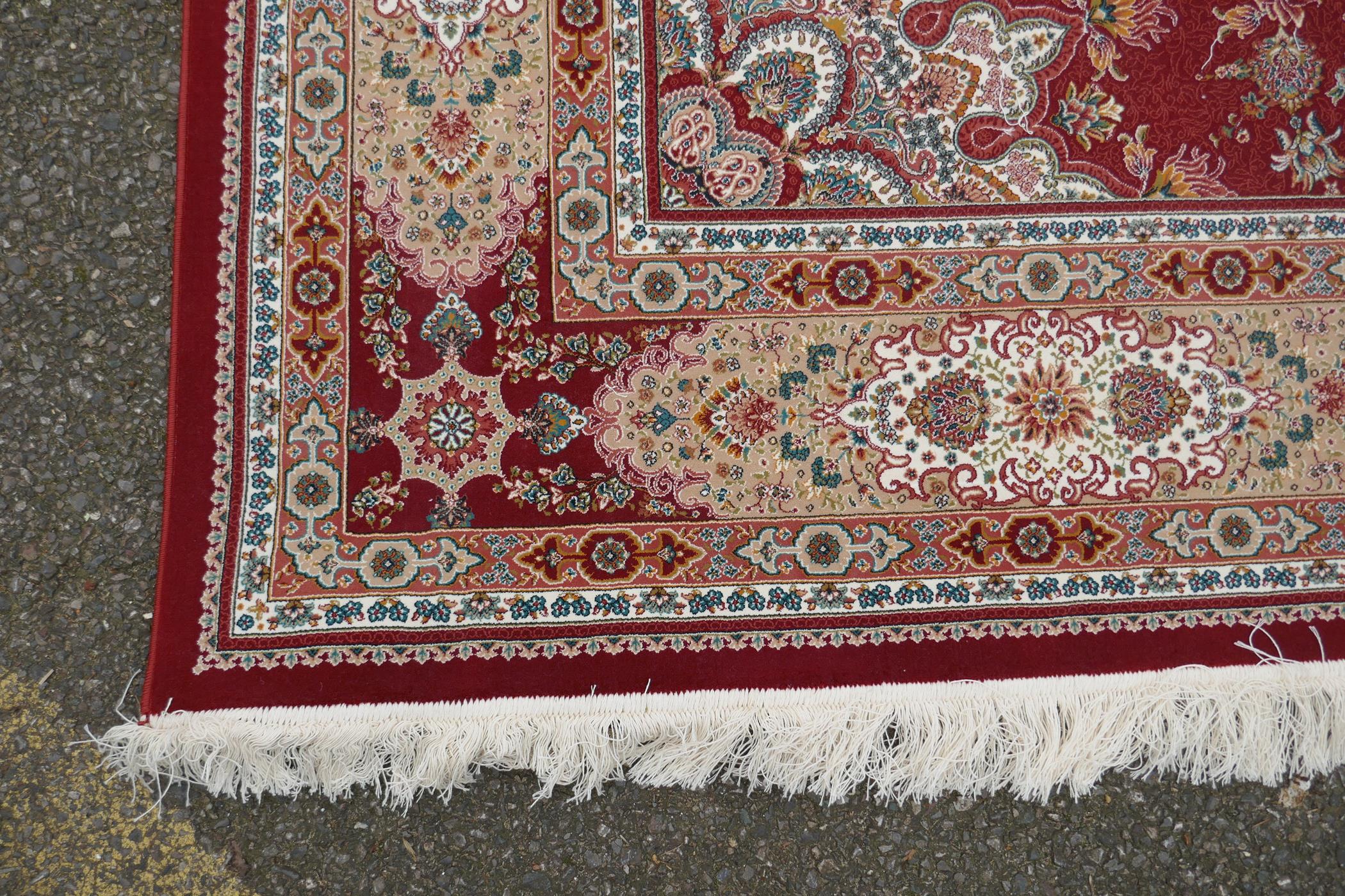 A fine woven full pile rich red ground Qom carpet, with floral medallion design and floral - Image 4 of 5