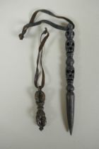 A Tibetan steel phurba with skull mask decorated to the handle and a miniature bronze vajra, 14cm