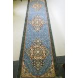 An Iranian fine woven blue ground runner with a medallion design and darker blue border, 80 x 310cm