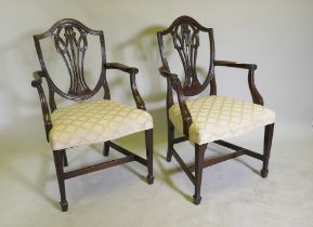 A pair of Hepplewhite style shield back mahogany elbow chairs, late C19th/early C20th