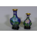 Two Chinese cloisonne vases, floral decoration on a blue ground, with wood stands, late C20th,