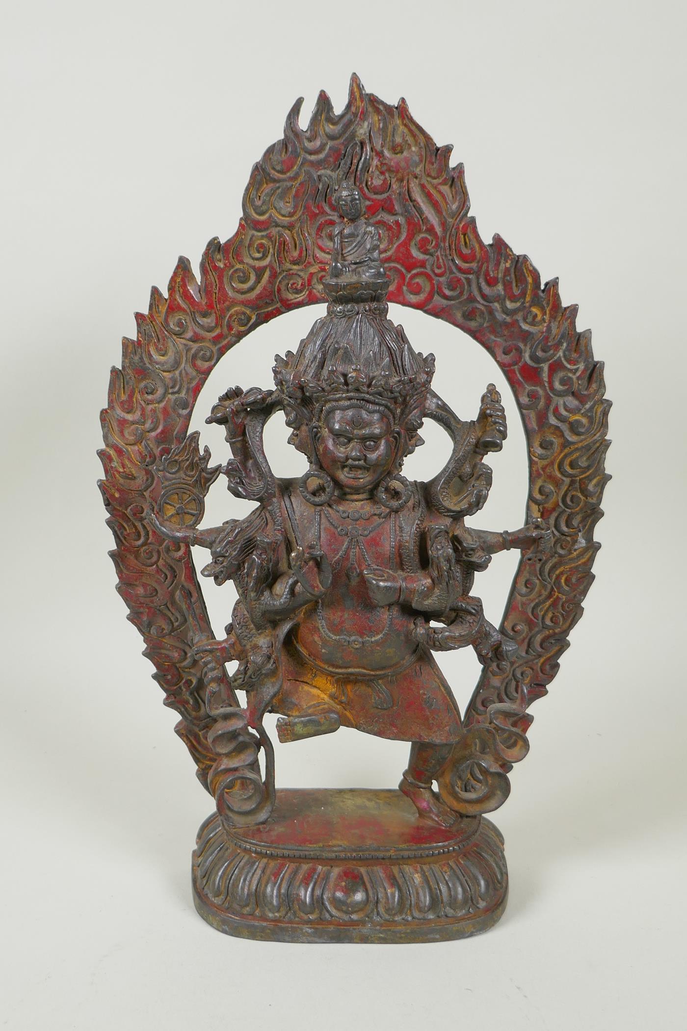A Tibetan bronze figure of Mahakala, with remnants of gilt patina, 33cm high, double vajra mark to