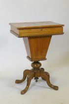 A Victorian inlaid walnut workbox, the rising top revealing a fitted interior, raised on carved