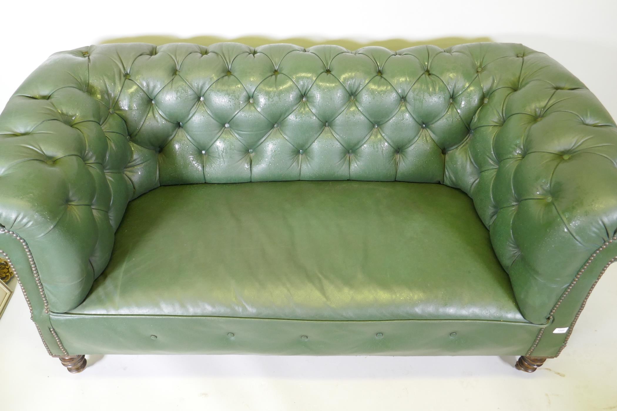 A Victorian button back leather Chesterfield settee, raised on turned supports, 165cm wide - Image 2 of 4