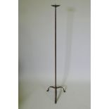 A wrought iron floor standing pricket candlestick, 129cm high